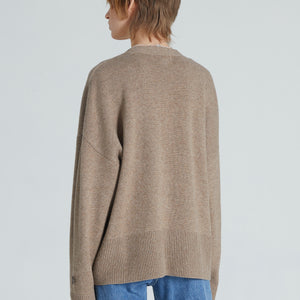 Back of a brown cashmere cardigan with long sleeves and relaxed fit. 