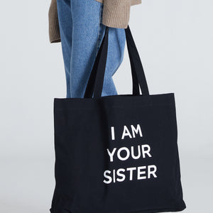 Black Tote Bag with print saying I AM YOUR SISTER

