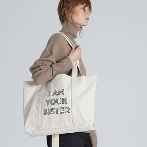 Profile of woman wearing the Lucie nature Tote Bag over her shoulder. 